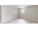 Bedroom with light walls, wood-look floors and a window provides a bright and inviting space at 10600 Oleander Dr, Port Richey, FL 34668