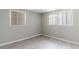 Minimalist bedroom with two windows, light-colored walls, and wood-look floors for a serene space at 10600 Oleander Dr, Port Richey, FL 34668