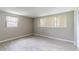 Bright bedroom featuring wood-look flooring, neutral paint, and windows with coverings at 10600 Oleander Dr, Port Richey, FL 34668