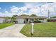 Exterior shot of the home showing the front yard, driveway, and a white mailbox at 10600 Oleander Dr, Port Richey, FL 34668