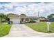 Front exterior of home showing the garage, driveway and front yard at 10600 Oleander Dr, Port Richey, FL 34668