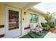 Covered front porch with rocking chairs and a view of the neighborhood at 10600 Oleander Dr, Port Richey, FL 34668