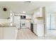 Well-lit kitchen with white cabinets, sleek black appliances, and modern countertops offers a clean design at 10600 Oleander Dr, Port Richey, FL 34668