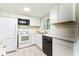 Beautiful kitchen featuring bright white cabinets, modern appliances, and a window above the sink at 10600 Oleander Dr, Port Richey, FL 34668