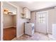Spacious laundry room with washer and dryer hookups, cabinetry and access to the backyard at 10600 Oleander Dr, Port Richey, FL 34668