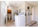 Functional laundry room featuring washer, dryer, hot water heater and access to a bathroom at 10600 Oleander Dr, Port Richey, FL 34668