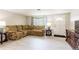 Living room with tile floors, a comfortable sofa, and a modern TV stand at 10600 Oleander Dr, Port Richey, FL 34668
