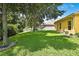 Lush backyard with mature trees and a well-manicured lawn offers privacy and shade at 11204 Biddeford Pl, New Port Richey, FL 34654