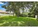 Expansive backyard with a manicured lawn and mature trees, offering a perfect outdoor space at 11204 Biddeford Pl, New Port Richey, FL 34654
