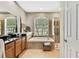 Bathroom features a large soaking tub, walk-in shower and double sinks at 11204 Biddeford Pl, New Port Richey, FL 34654