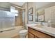 Clean bathroom with a shower/tub combination, tile surround, and a modern vanity at 11204 Biddeford Pl, New Port Richey, FL 34654