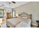 Cozy bedroom features a ceiling fan, wood flooring and an iron bed frame at 11204 Biddeford Pl, New Port Richey, FL 34654