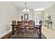 Bright dining room with a dining table and chairs set upon a decorative tile floor with a chandelier at 11204 Biddeford Pl, New Port Richey, FL 34654