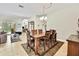Open concept dining room area with an archway view into the living room and tile floors at 11204 Biddeford Pl, New Port Richey, FL 34654