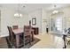 Elegant dining room with a wooden table, chandelier, and tiled flooring at 11204 Biddeford Pl, New Port Richey, FL 34654