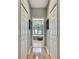 Hallway view to soaking tub with natural light and dual closets at 11204 Biddeford Pl, New Port Richey, FL 34654