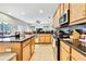 Modern kitchen with granite countertops, stainless steel appliances, and open layout to living area at 11204 Biddeford Pl, New Port Richey, FL 34654