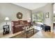 Cozy living room with a sliding glass door, a mauve sofa, and a decorative mirror at 11204 Biddeford Pl, New Port Richey, FL 34654