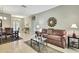 Inviting living room with tile flooring, comfortable sofa, and stylish decor, perfect for relaxation and entertaining at 11204 Biddeford Pl, New Port Richey, FL 34654