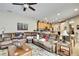 Comfortable living room open to kitchen area, featuring a cozy sectional and ample lighting at 11204 Biddeford Pl, New Port Richey, FL 34654