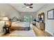 Inviting main bedroom featuring hardwood floors, a ceiling fan, and sliding glass doors to the backyard at 11204 Biddeford Pl, New Port Richey, FL 34654