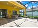 Enclosed patio with ample seating, a ceiling fan, and an outdoor dining table at 11204 Biddeford Pl, New Port Richey, FL 34654