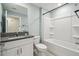 Bathroom featuring a granite countertop vanity, a toilet, and a tub with shower at 11395 Lavender Loop, Spring Hill, FL 34609
