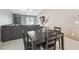 Cozy dining area featuring a dark wood table with seating for four, adjacent to the living room at 11395 Lavender Loop, Spring Hill, FL 34609