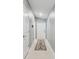 Clean entryway featuring tile flooring, light gray walls, and a decorative rug leading to the front door at 11395 Lavender Loop, Spring Hill, FL 34609