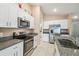 Well-equipped kitchen featuring stainless steel appliances, granite counters, and ample white cabinet storage at 11395 Lavender Loop, Spring Hill, FL 34609
