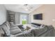 Comfortable living room with a large sectional sofa, ceiling fan, and sliding glass doors to the outdoor space at 11395 Lavender Loop, Spring Hill, FL 34609