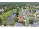 Aerial view showcases this home's serene pond-side setting in a quiet neighborhood at 11418 Tee Time Cir, New Port Richey, FL 34654