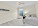 Cozy bedroom with a single bed, neutral walls, and a window offering ample natural light at 11418 Tee Time Cir, New Port Richey, FL 34654