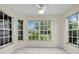 Bright breakfast nook surrounded by windows offering serene outdoor views and tile flooring at 11418 Tee Time Cir, New Port Richey, FL 34654