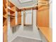 Spacious walk-in closet featuring custom wood shelving and ample storage space for an organized wardrobe at 11418 Tee Time Cir, New Port Richey, FL 34654