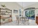 Cozy dining area with a decorative chandelier, shelving, and a view of the outdoors at 11418 Tee Time Cir, New Port Richey, FL 34654