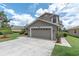 Exterior of home boasts a two-car garage, neutral paint, and manicured landscaping at 11418 Tee Time Cir, New Port Richey, FL 34654