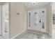 Bright foyer featuring a decorative glass front door, neutral walls, and tiled floors at 11418 Tee Time Cir, New Port Richey, FL 34654