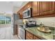 Kitchen area featuring stainless steel appliances, breakfast nook, and tile backsplash at 11418 Tee Time Cir, New Port Richey, FL 34654