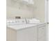 Laundry room featuring a white washer and dryer with shelving and stacked clean white towels at 11418 Tee Time Cir, New Port Richey, FL 34654