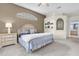 Serene bedroom with neutral tones, arched window, and coordinated decor. Adjacent to main bathroom at 11418 Tee Time Cir, New Port Richey, FL 34654