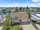 Waterfront home with a canal view, featuring a manicured lawn and a garage at 13027 Beacon Ct, Hudson, FL 34667