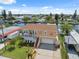 Aerial view of waterfront home featuring a well-kept yard, two-car garage, and nearby canal access at 13027 Beacon Ct, Hudson, FL 34667