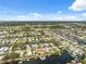 Picturesque aerial view of waterfront homes situated on winding canals leading to the ocean, surrounded by greenery at 13027 Beacon Ct, Hudson, FL 34667