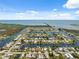 Expansive aerial shot showcasing waterfront community homes along canals with easy access to the ocean at 13027 Beacon Ct, Hudson, FL 34667