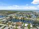 Expansive aerial view showcasing waterfront properties nestled along winding canals with access to open water and the ocean at 13027 Beacon Ct, Hudson, FL 34667
