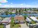 Aerial shot of a waterfront home with canal access, well-kept yard, and charming curb appeal at 13027 Beacon Ct, Hudson, FL 34667