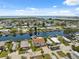 Panoramic aerial view of a vibrant waterfront community with homes nestled along winding canals and open water access at 13027 Beacon Ct, Hudson, FL 34667