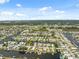 Captivating aerial view of a vast community, with homes nestled along winding canals and lush greenery at 13027 Beacon Ct, Hudson, FL 34667