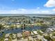 Stunning aerial view of a waterfront community, showcasing homes with canal access, and proximity to open water at 13027 Beacon Ct, Hudson, FL 34667